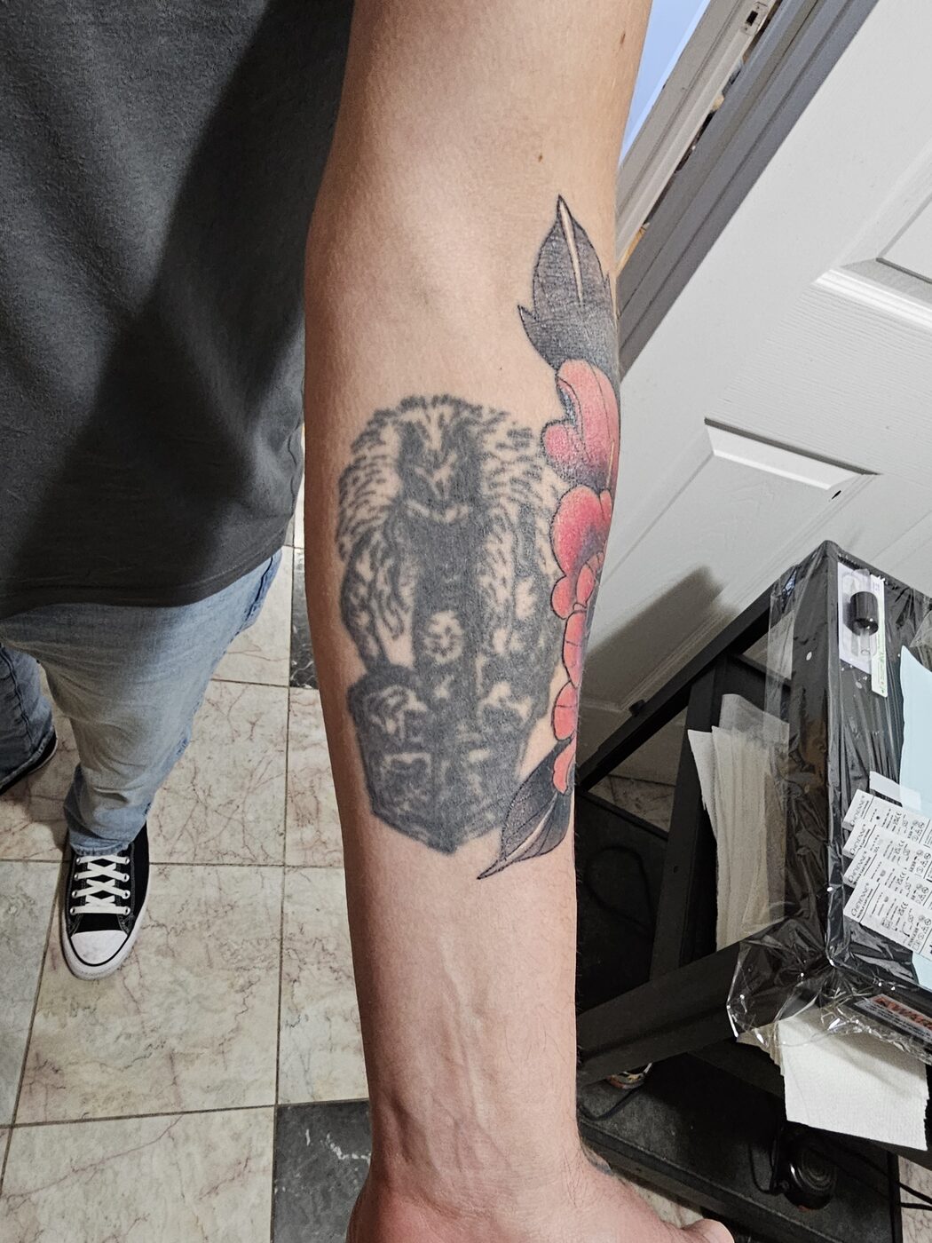 Old forearm tattoo before Guy Abergel covered it