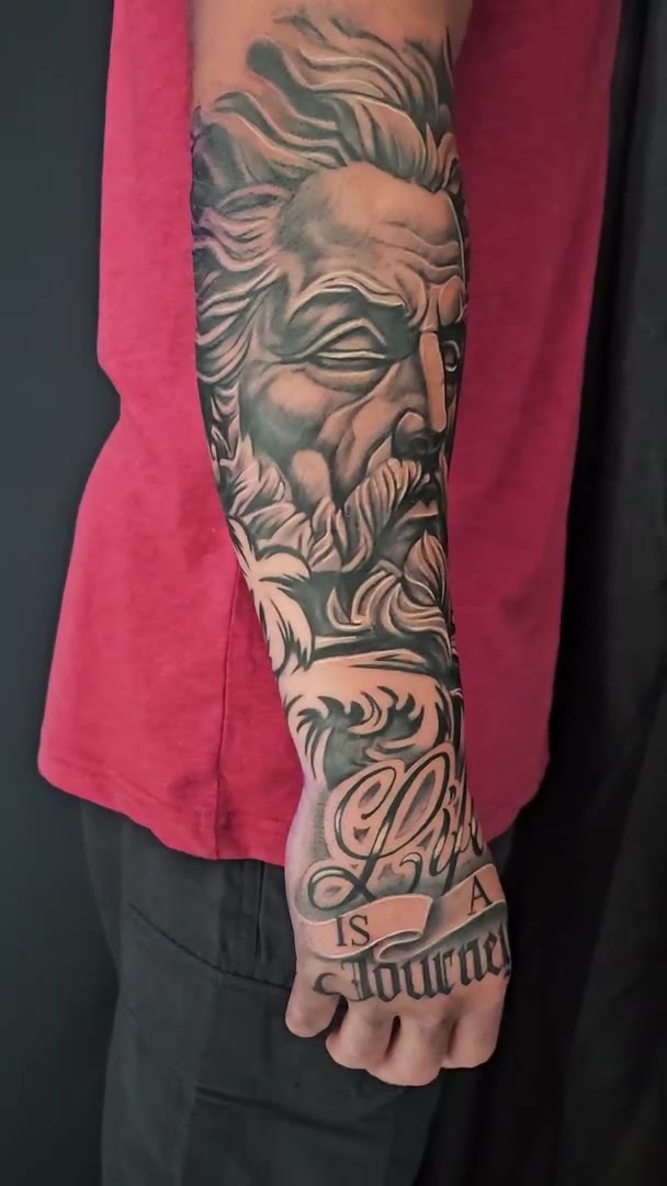 Black-and-grey forearm tattoo by Guy Abergel