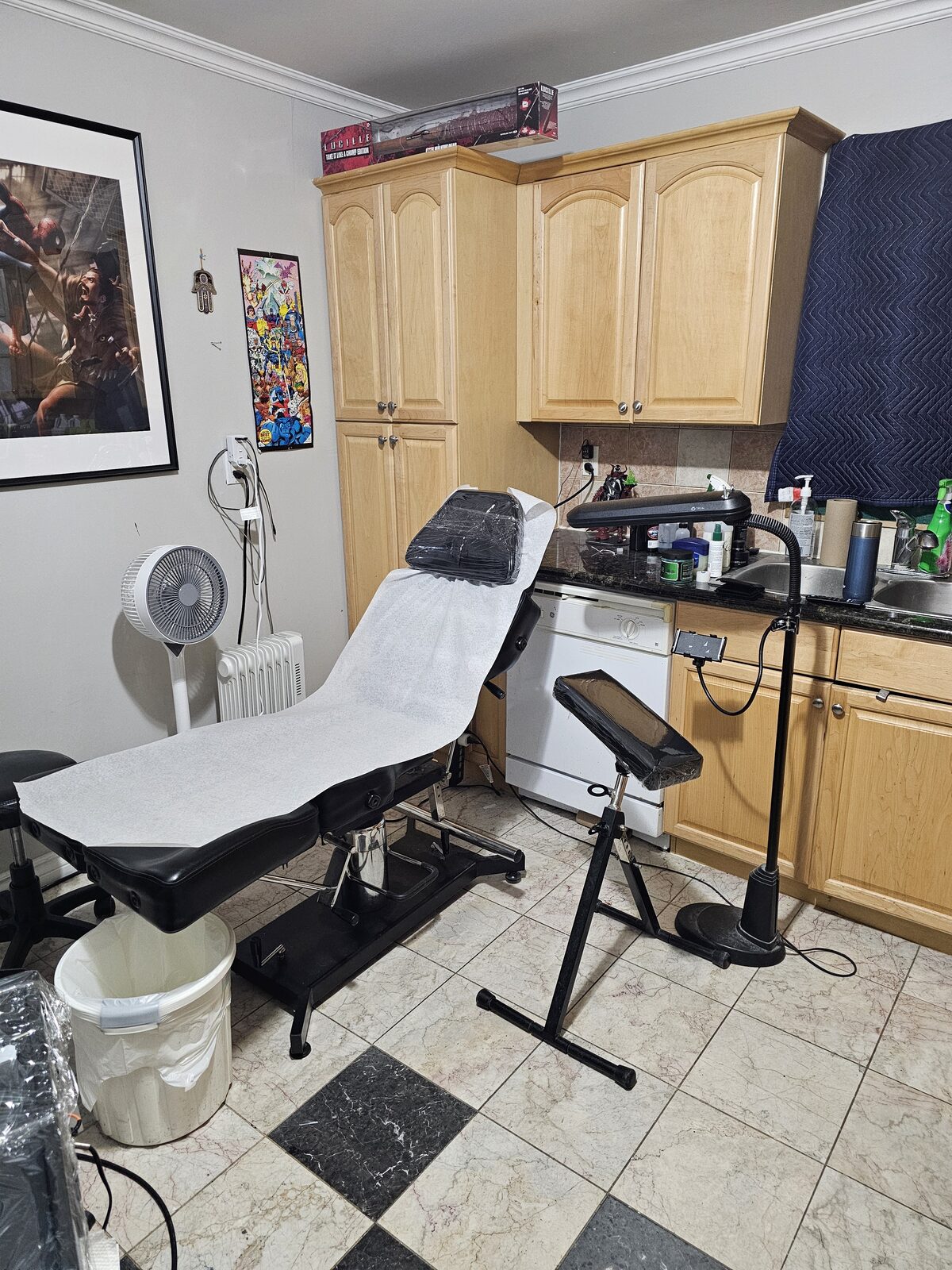 The tattoo station at Art Studio Tattoos, with framed artwork on the walls