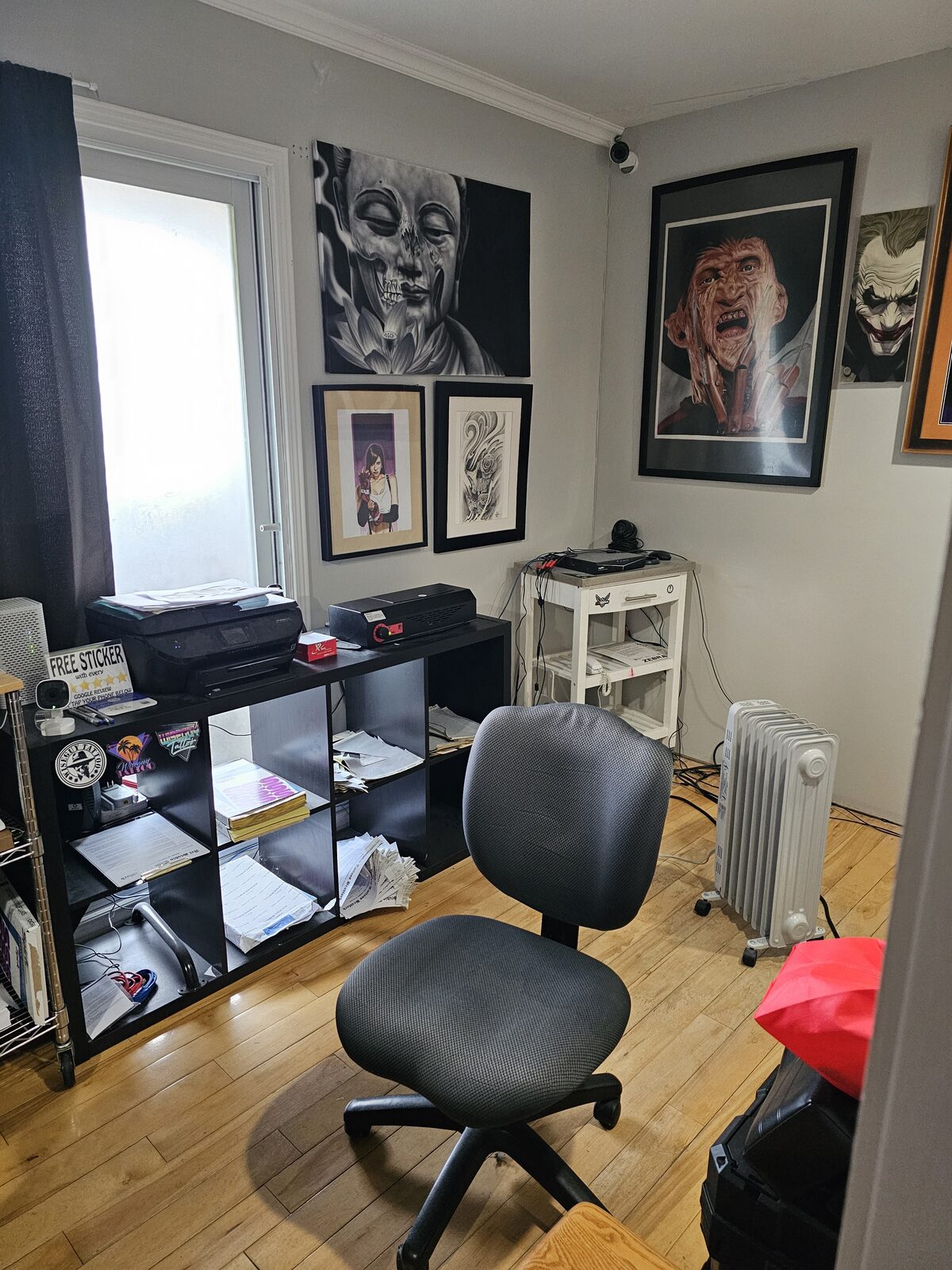 Studio wall lined with Guy Abergel's framed artwork